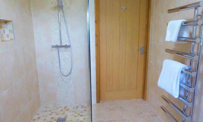 This disabled friendly communal bathroom with shower is situated on the ground floor and provides level access from the ground floor rooms.